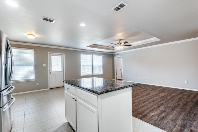 3109 Layla Creek Dr, Little Elm, TX 75068 - kitchen with stainless steel refrigerator with ice dispenser, crown molding, a tray ceiling, a center island, and a ceiling fan