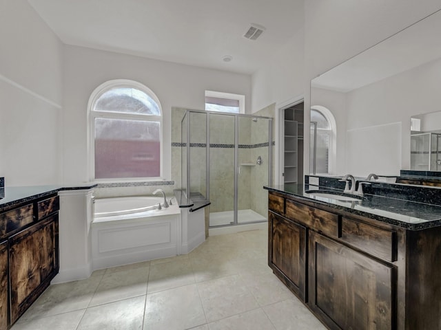 12815 Lourdes Ln, Frisco, TX 75035 - bathroom with a stall shower, vanity, a garden tub, and tile patterned flooring
