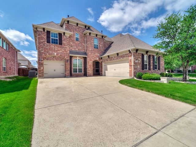 12815 Lourdes Ln, Frisco, TX 75035 - view of front of home featuring concrete driveway, brick siding, a front yard, a garage, and roof with shingles