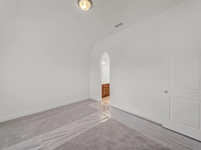 12815 Lourdes Ln, Frisco, TX 75035 - unfurnished room featuring light carpet, arched walkways, and vaulted ceiling