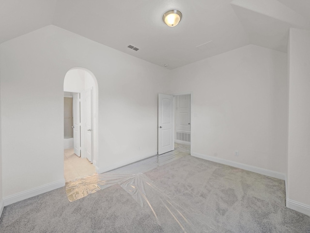12815 Lourdes Ln, Frisco, TX 75035 - unfurnished bedroom with vaulted ceiling, carpet, and arched walkways
