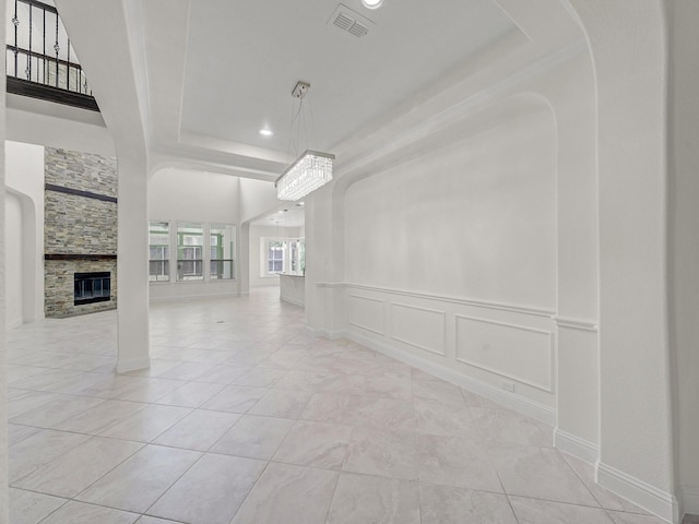 12815 Lourdes Ln, Frisco, TX 75035 - unfurnished living room with recessed lighting, tile patterned floors, and a stone fireplace