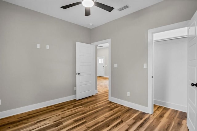 1002 E Main, Whitehouse, TX 75791 - unfurnished bedroom with wood finished floors, a ceiling fan, and a closet