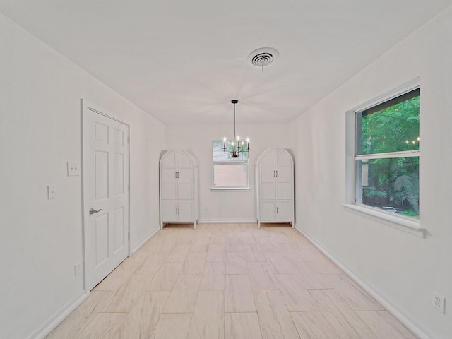 5537 Wheaton Dr, Fort Worth, TX 76133 - spare room featuring a chandelier and baseboards