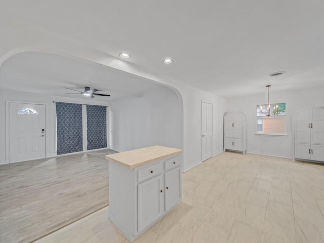 5537 Wheaton Dr, Fort Worth, TX 76133 - unfurnished living room with arched walkways, ceiling fan, a chandelier, and recessed lighting