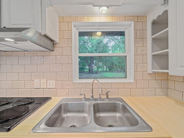 5537 Wheaton Dr, Fort Worth, TX 76133 - kitchen featuring light countertops, black electric stovetop, tasteful backsplash, and ventilation hood