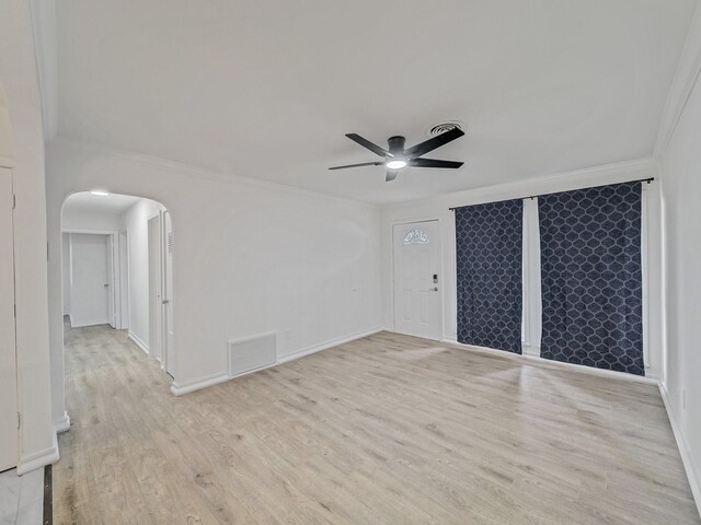 5537 Wheaton Dr, Fort Worth, TX 76133 - unfurnished room with arched walkways, a ceiling fan, ornamental molding, and wood finished floors