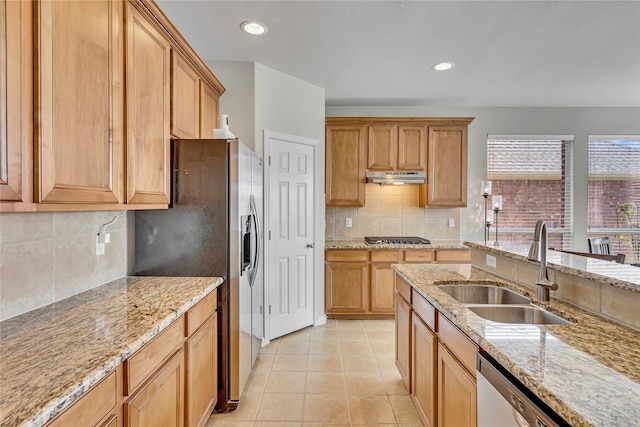 3537 Navarro Way, Frisco, TX 75034 - kitchen with under cabinet range hood, stainless steel appliances, decorative backsplash, light stone counters, and light tile patterned floors