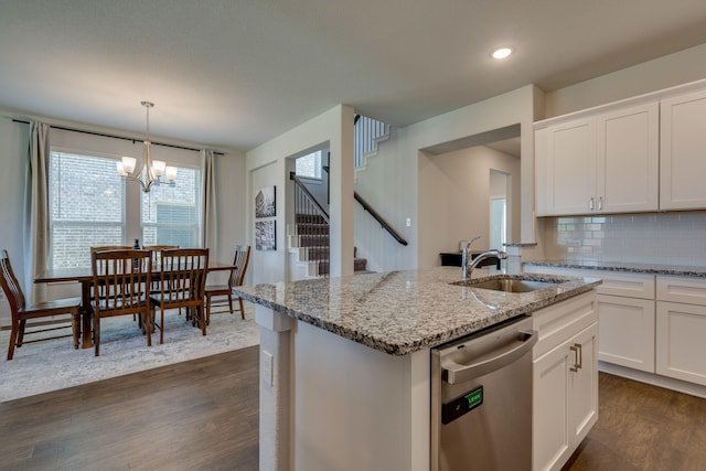 14613 Martin Creek Cv, Fort Worth, TX 76262 - kitchen featuring stainless steel dishwasher, dark wood finished floors, tasteful backsplash, white cabinetry, and light stone counters