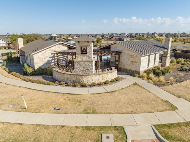 14613 Martin Creek Cv, Fort Worth, TX 76262 - view of front of home featuring stone siding, a residential view, a chimney, and a standing seam roof