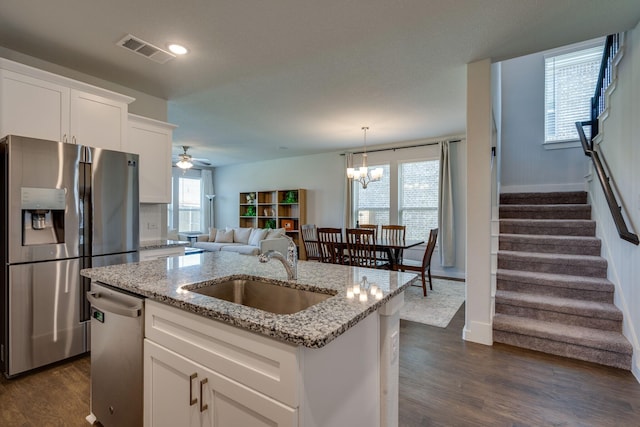 14613 Martin Creek Cv, Fort Worth, TX 76262 - kitchen with appliances with stainless steel finishes, a ceiling fan, dark wood-style flooring, white cabinets, and a center island with sink