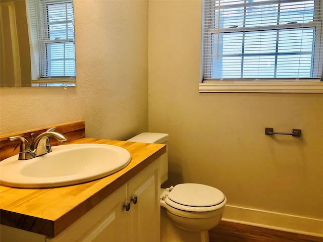 716 Kessler Blvd, Sherman, TX 75092 - half bathroom with healthy amount of natural light, vanity, wood finished floors, and a textured wall