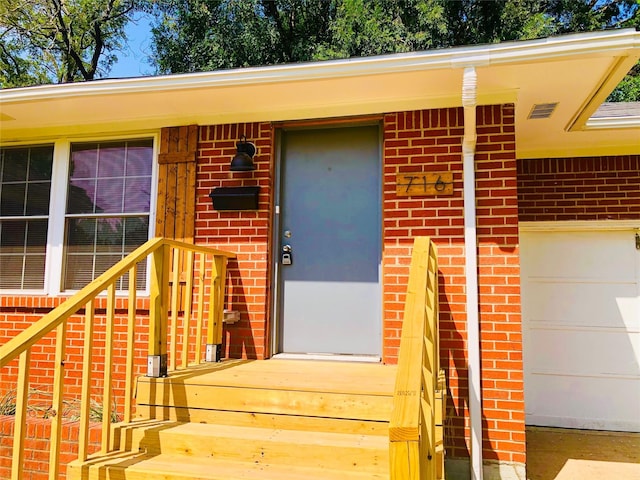 716 Kessler Blvd, Sherman, TX 75092 - view of exterior entry with brick siding and a garage