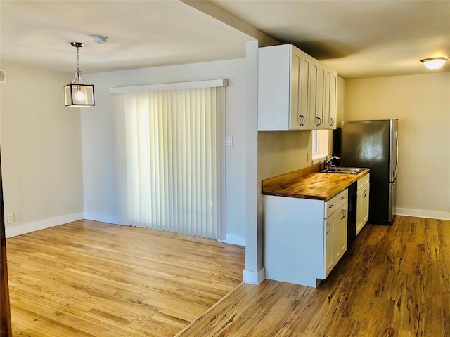 716 Kessler Blvd, Sherman, TX 75092 - kitchen featuring wooden counters, wood finished floors, white cabinets, and dishwasher
