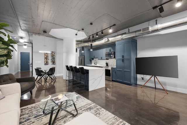1122 Jackson St Unit 418, Dallas, TX 75202 - living room with finished concrete flooring and rail lighting