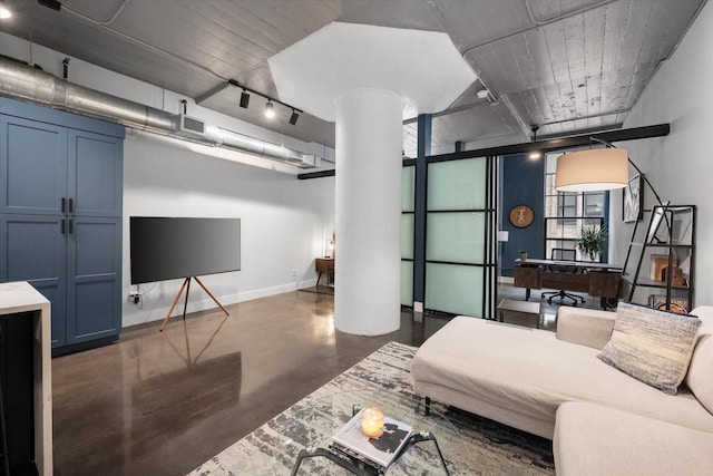 1122 Jackson St Unit 418, Dallas, TX 75202 - living room featuring finished concrete flooring, ornate columns, and rail lighting
