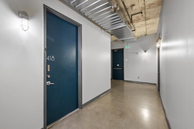 1122 Jackson St Unit 418, Dallas, TX 75202 - hallway featuring baseboards and concrete floors
