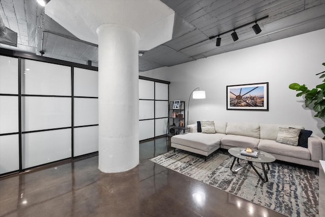 1122 Jackson St Unit 418, Dallas, TX 75202 - living area with ornate columns and finished concrete flooring