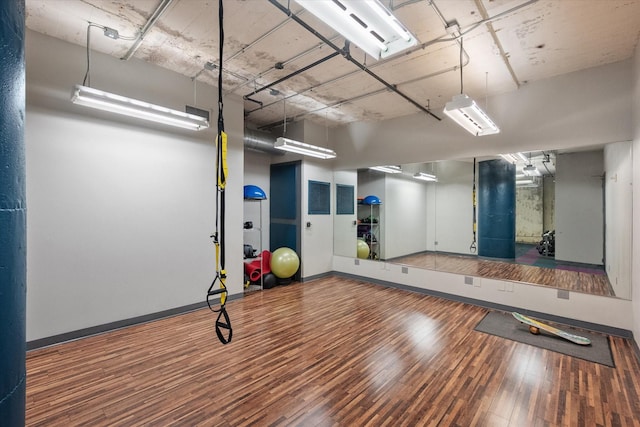 1122 Jackson St Unit 418, Dallas, TX 75202 - workout area featuring wood-type flooring and baseboards