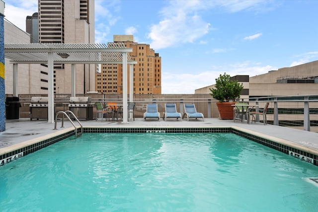 1122 Jackson St Unit 418, Dallas, TX 75202 - community pool with a pergola, a patio, and exterior kitchen