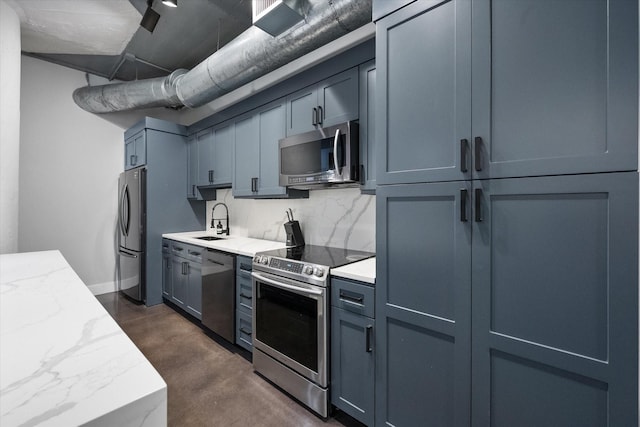 1122 Jackson St Unit 418, Dallas, TX 75202 - kitchen with stainless steel appliances, concrete flooring, light stone countertops, and backsplash