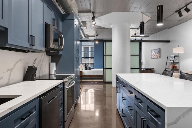 1122 Jackson St Unit 418, Dallas, TX 75202 - kitchen featuring appliances with stainless steel finishes, finished concrete floors, ornate columns, a kitchen island, and open floor plan