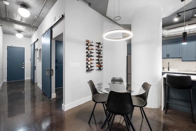 1122 Jackson St Unit 418, Dallas, TX 75202 - dining space featuring finished concrete flooring and a barn door