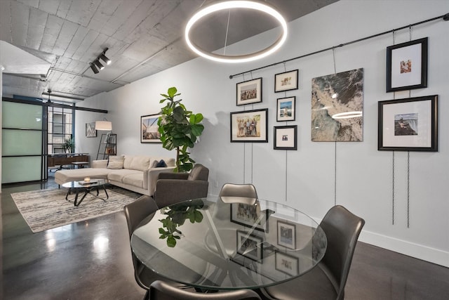 1122 Jackson St Unit 418, Dallas, TX 75202 - dining area featuring baseboards and finished concrete floors