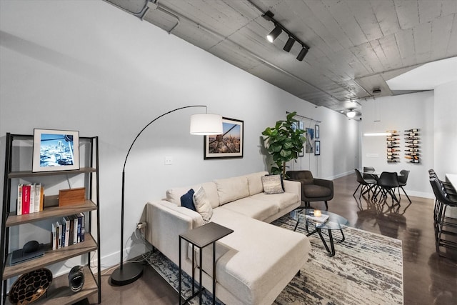 1122 Jackson St Unit 418, Dallas, TX 75202 - living room featuring baseboards and rail lighting