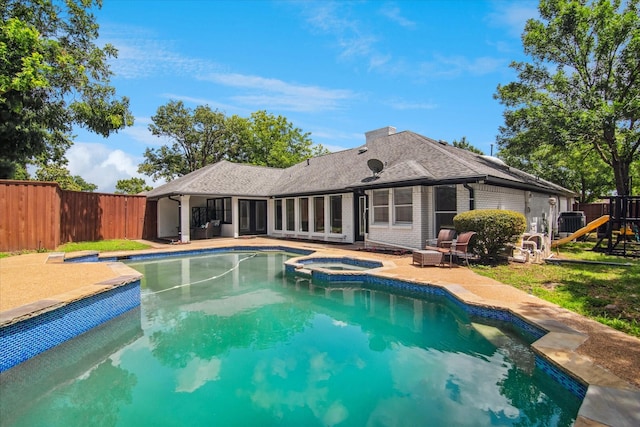 813 Lakeshore Dr, Mesquite, TX 75149 - view of swimming pool with a patio area, a fenced backyard, a playground, and a pool with connected hot tub