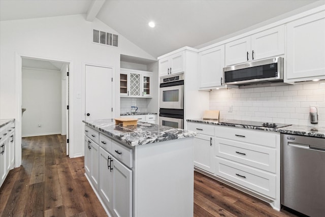 813 Lakeshore Dr, Mesquite, TX 75149 - kitchen with stainless steel appliances, a center island, white cabinets, decorative backsplash, and recessed lighting