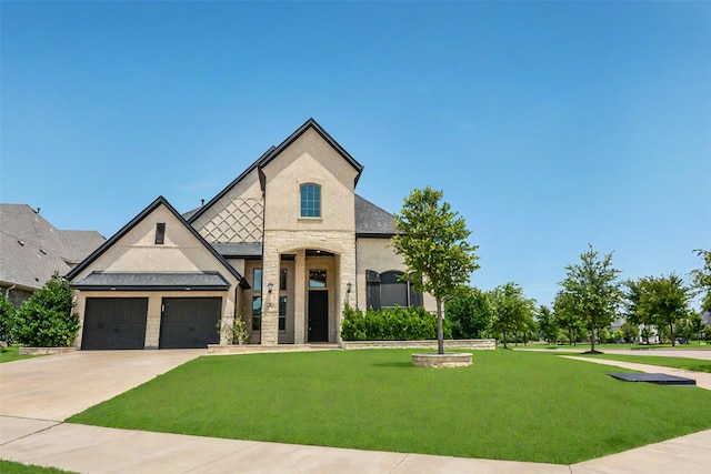9714 Minister Ln, Frisco, TX 75035 - french country style house featuring a front lawn, an attached garage, concrete driveway, and stone siding