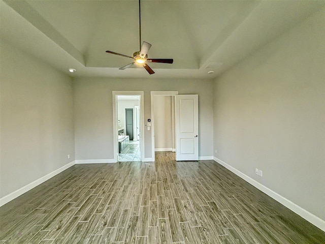 9714 Minister Ln, Frisco, TX 75035 - empty room featuring a raised ceiling, wood finished floors, and a ceiling fan