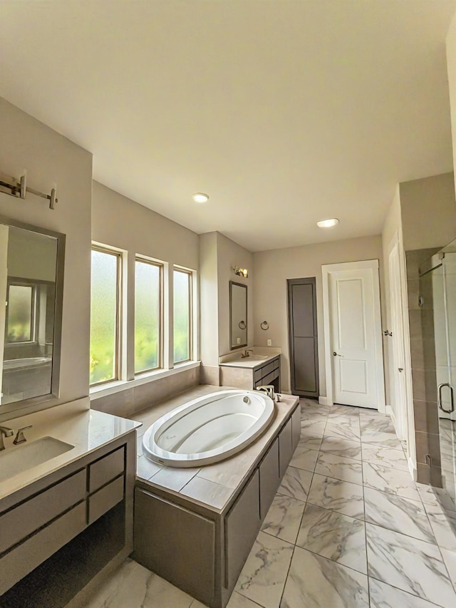 9714 Minister Ln, Frisco, TX 75035 - full bath featuring marble look tiles, a stall shower, a bath, two vanities, and recessed lighting