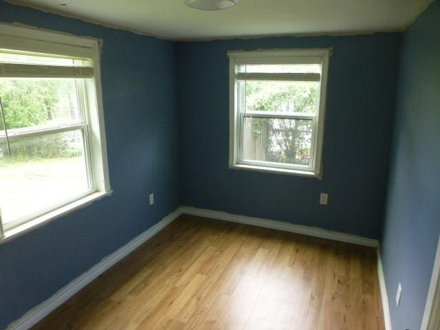 408 Soward Ave, Weatherford, TX 76086 - empty room with plenty of natural light and wood finished floors