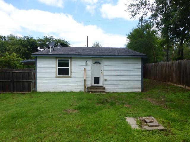 408 Soward Ave, Weatherford, TX 76086 - rear view of house with entry steps and a fenced backyard