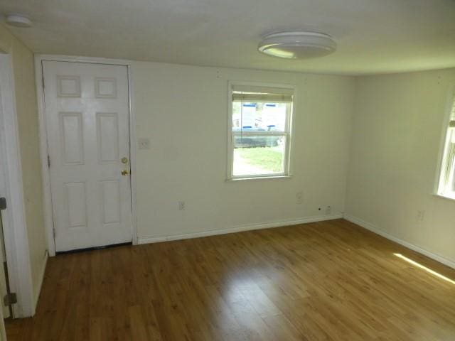 408 Soward Ave, Weatherford, TX 76086 - unfurnished room featuring healthy amount of natural light, wood finished floors, and a smoke detector