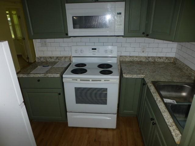408 Soward Ave, Weatherford, TX 76086 - kitchen with white appliances, dark wood finished floors, decorative backsplash, and light stone countertops