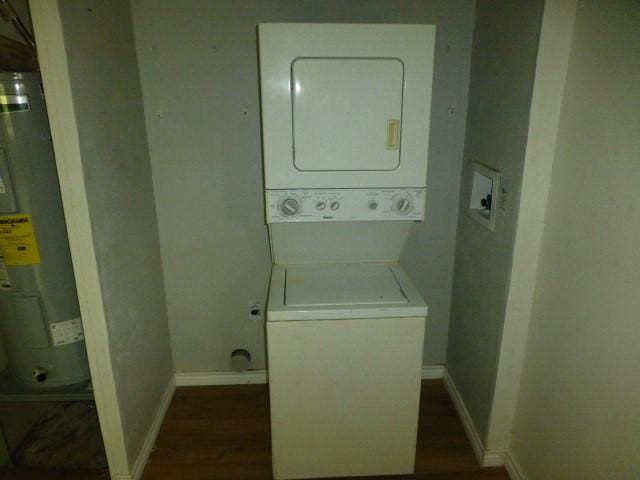 408 Soward Ave, Weatherford, TX 76086 - laundry room with estacked washer and dryer, water heater, and dark wood-style floors