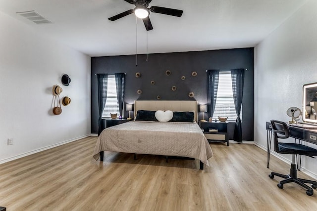 7113 Wavecrest Way, Fort Worth, TX 76179 - bedroom featuring wood finished floors, an accent wall, a ceiling fan, and an office area