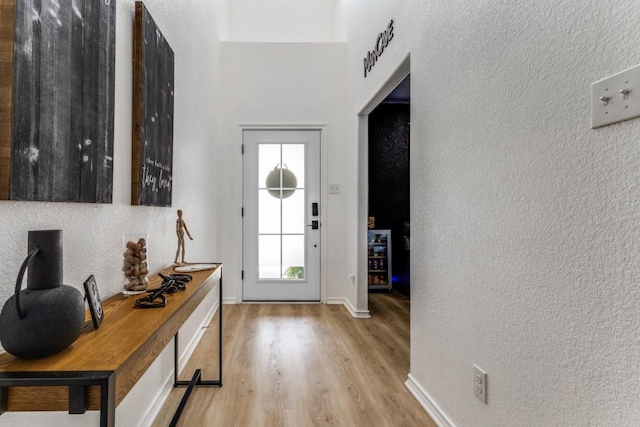 7113 Wavecrest Way, Fort Worth, TX 76179 - entrance foyer with light wood-type flooring, a textured wall, and a towering ceiling