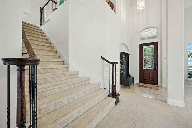 890 Wind Brook Ln, Prosper, TX 75078 - foyer entrance with stairway, carpet floors, and a towering ceiling