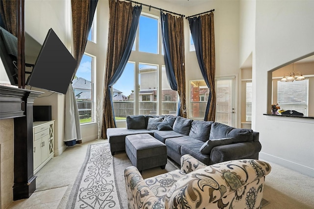 890 Wind Brook Ln, Prosper, TX 75078 - living area with light carpet, a towering ceiling, plenty of natural light, and a chandelier