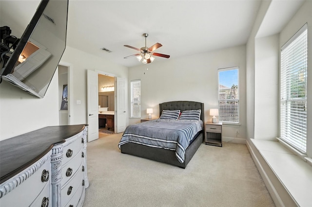 890 Wind Brook Ln, Prosper, TX 75078 - bedroom with multiple windows, light carpet, ensuite bathroom, and a ceiling fan