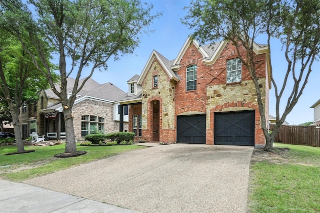 890 Wind Brook Ln, Prosper, TX 75078 - traditional home featuring driveway, stone siding, brick siding, and a garage