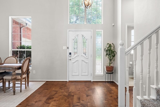 1413 Trinity Ct, Flower Mound, TX 75028 - entryway featuring a towering ceiling, healthy amount of natural light, dark wood finished floors, stairs, and a chandelier