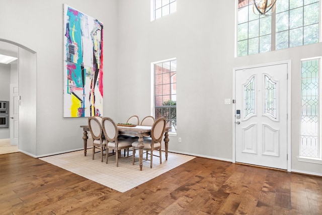 1413 Trinity Ct, Flower Mound, TX 75028 - dining room with a high ceiling, wood finished floors, and arched walkways