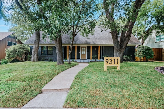 9311 Mercer Dr, Dallas, TX 75228 - view of front of home featuring roof with shingles, brick siding, and covered porch