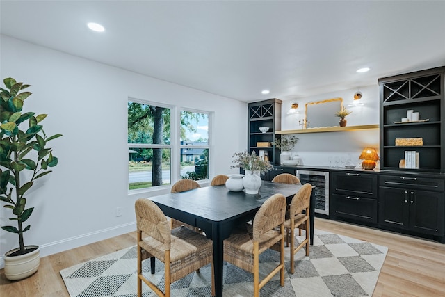 9311 Mercer Dr, Dallas, TX 75228 - dining space with beverage cooler, a bar, light wood-style floors, and recessed lighting
