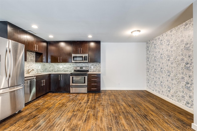 5816 Birchbrook Dr Unit 122, Dallas, TX 75206 - kitchen with appliances with stainless steel finishes, light countertops, dark wood-style flooring, dark brown cabinetry, and recessed lighting